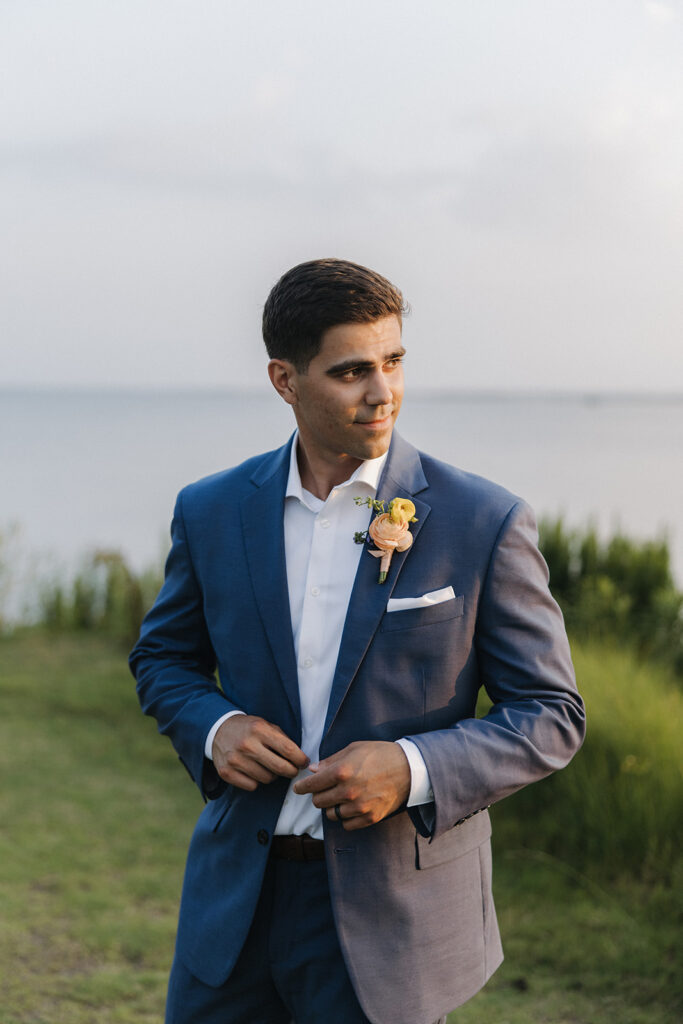 groom buttons up blue wedding suit