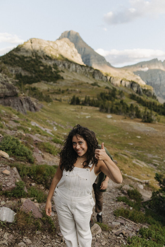 bride gives thumbs up at mountain engagement session