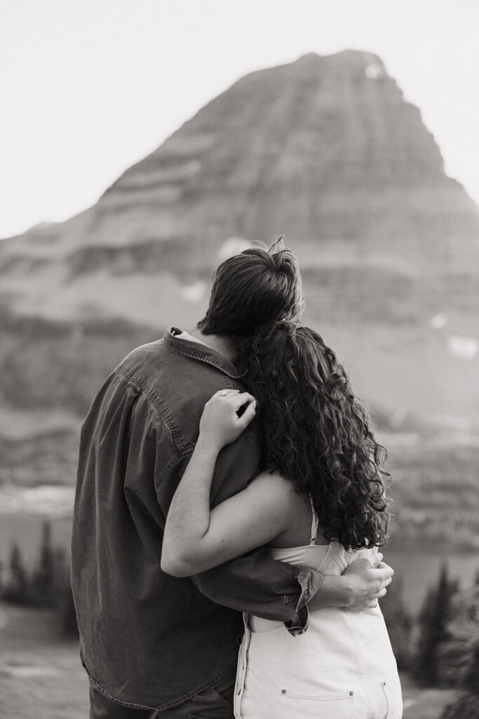 couple embraces at mountaintop engagement session