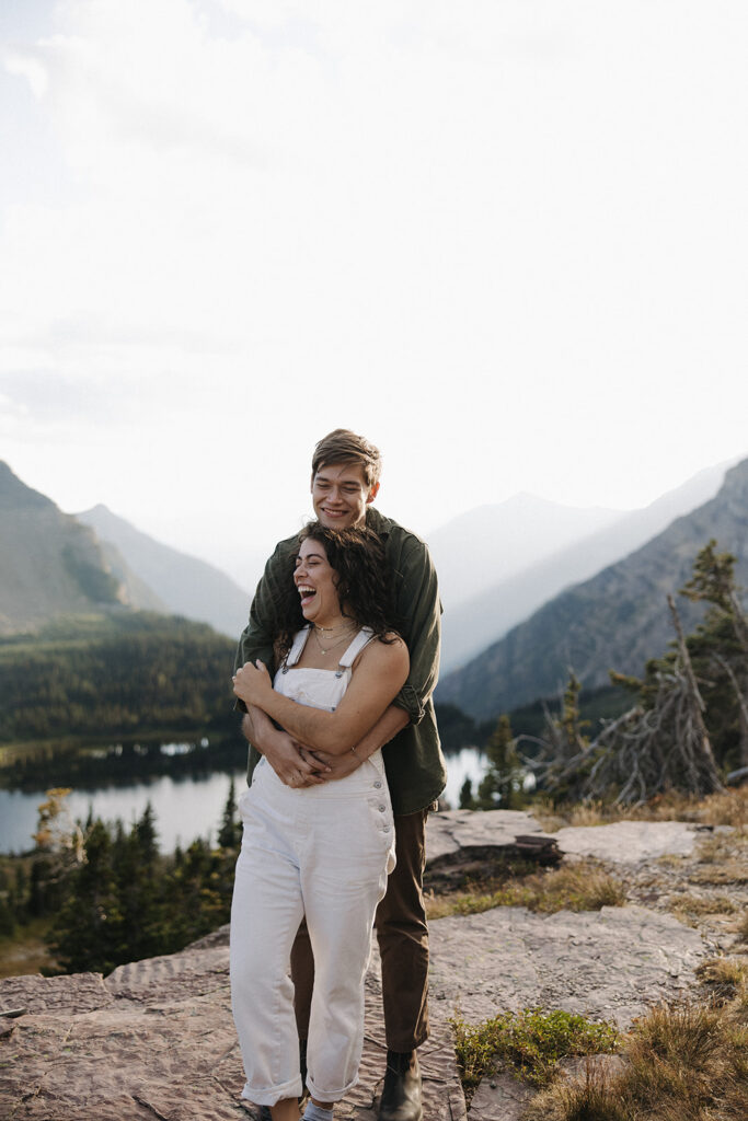 couple embraces at mountaintop engagement session