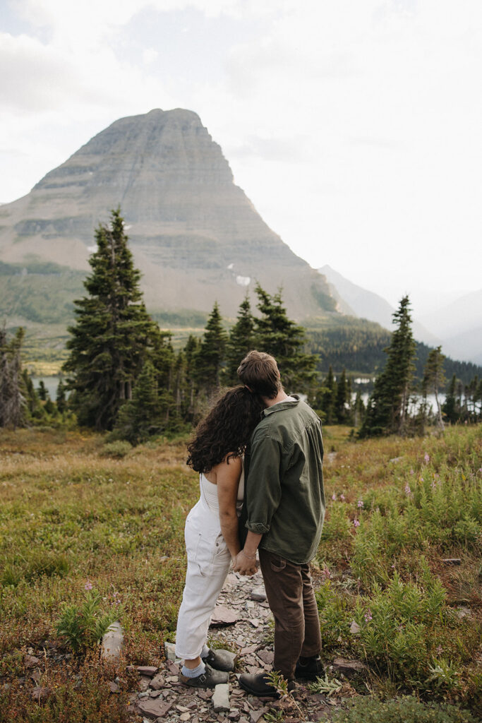 couple holds hands at Glacier National Park couples adventure