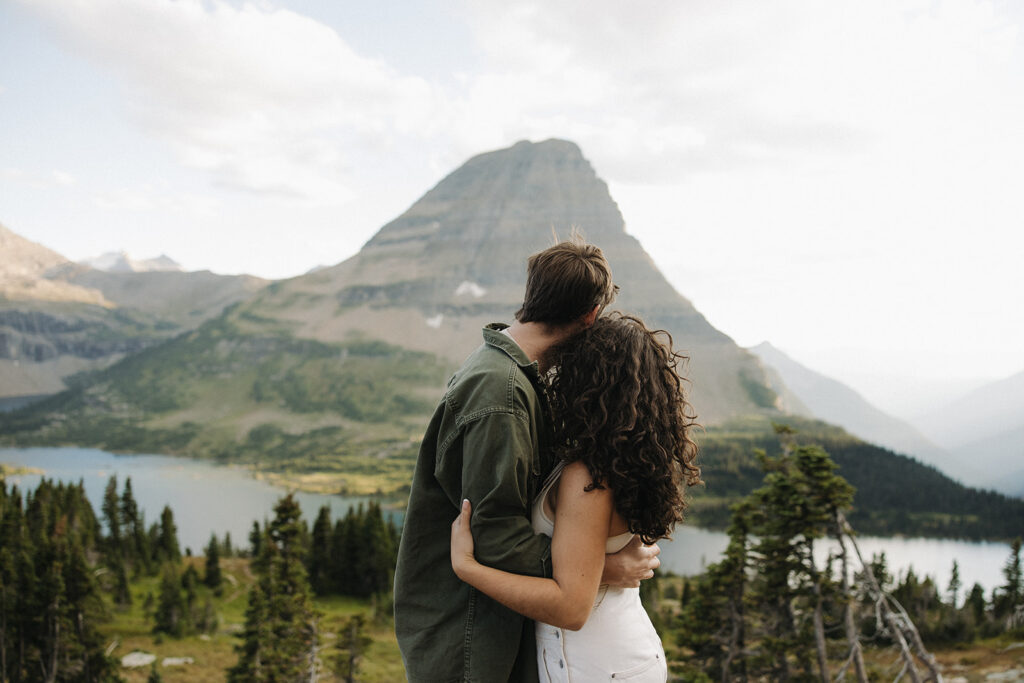couple embraces at Glacier National Park couples adventure