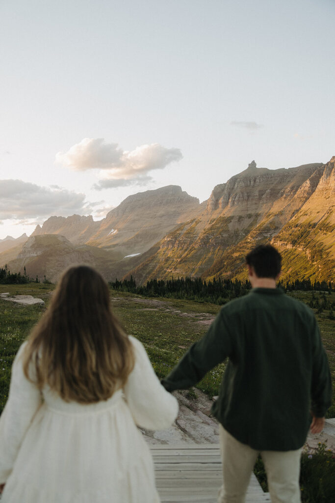 couple embraces at Glacier National Park sunset engagement