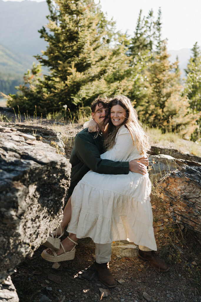 couple hugs at Glacier National Park forest engagement