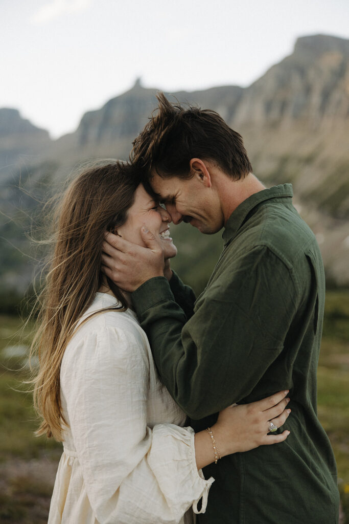 couple embraces at Glacier National Park engagement