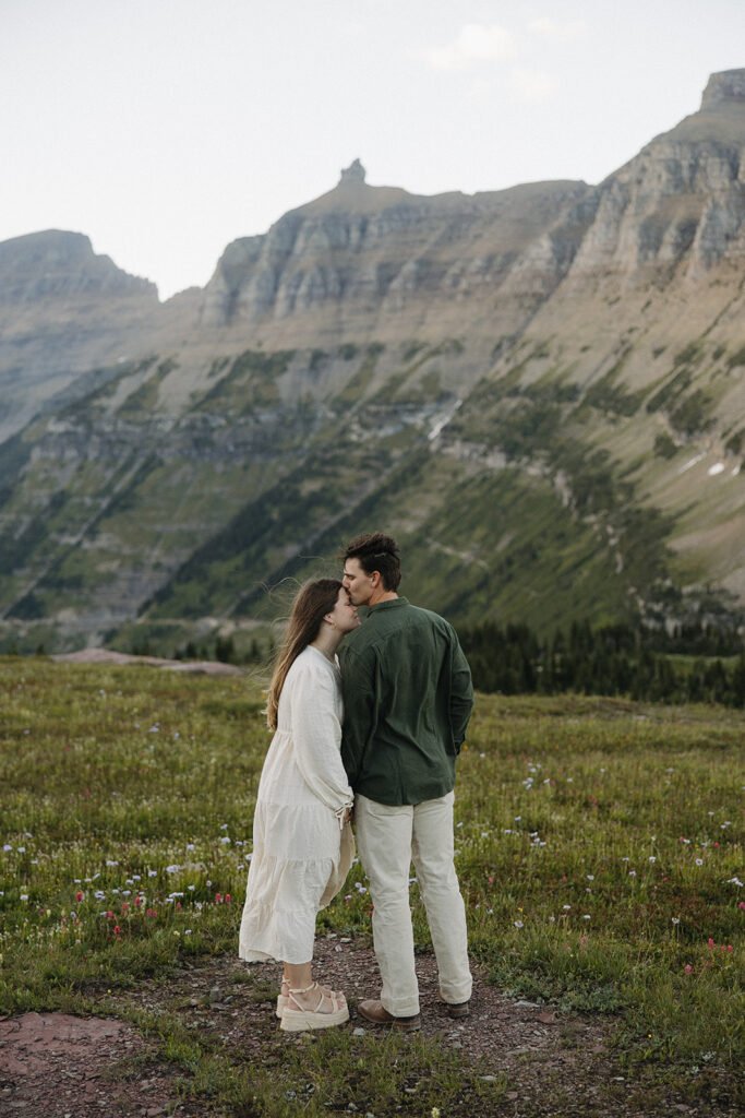 couple kisses at Glacier National Park engagement