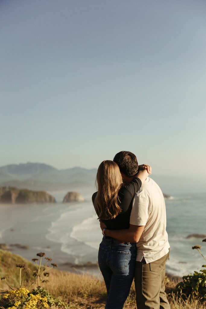 couple embraces at Oregon coast couples session