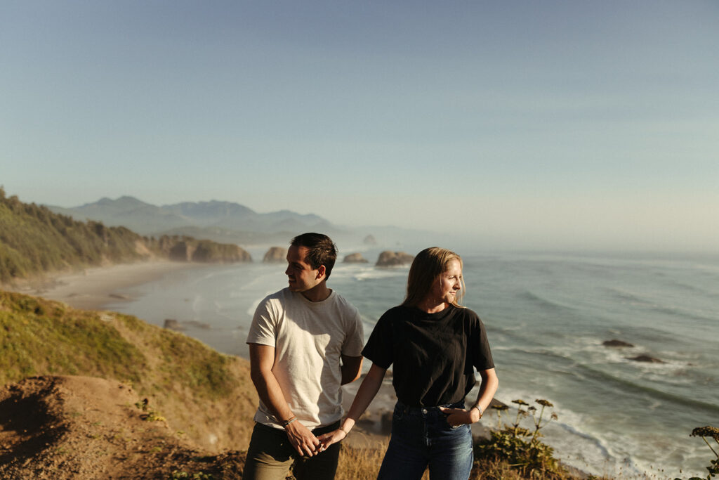 couple holds hands at Oregon coast couples session