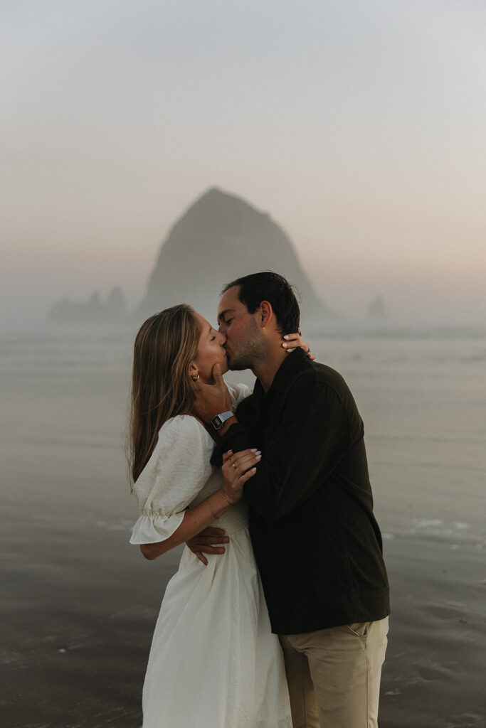 couple kisses at Cannon Beach sunset engagement session