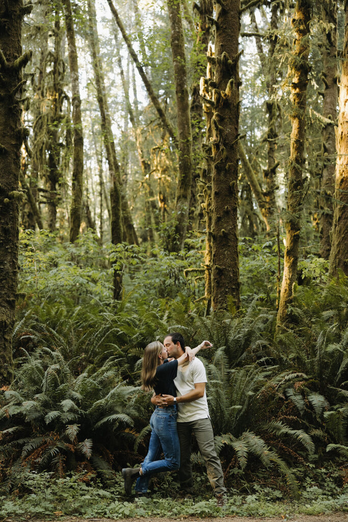 couple kisses in sunset woods engagement session