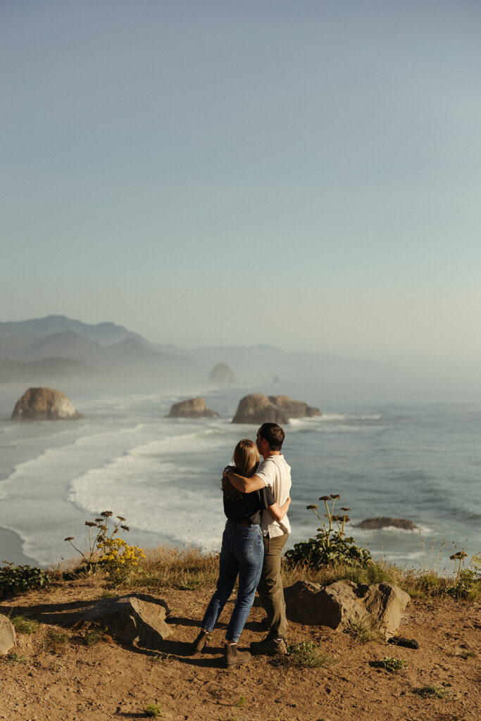 couple embraces at Oregon coast couples session
