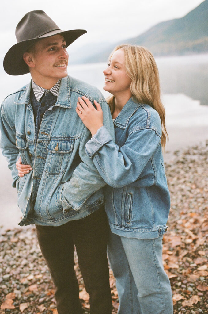 couple laughs holding each other with film photography on 35mm