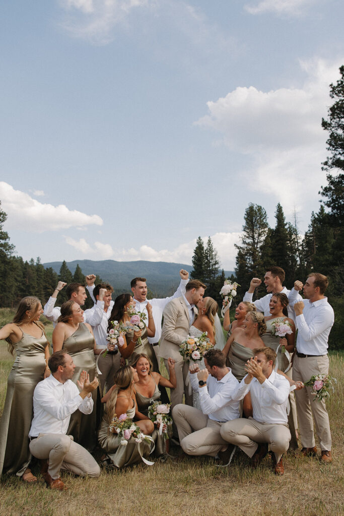 bridal party laughing and cheering for newlyweds