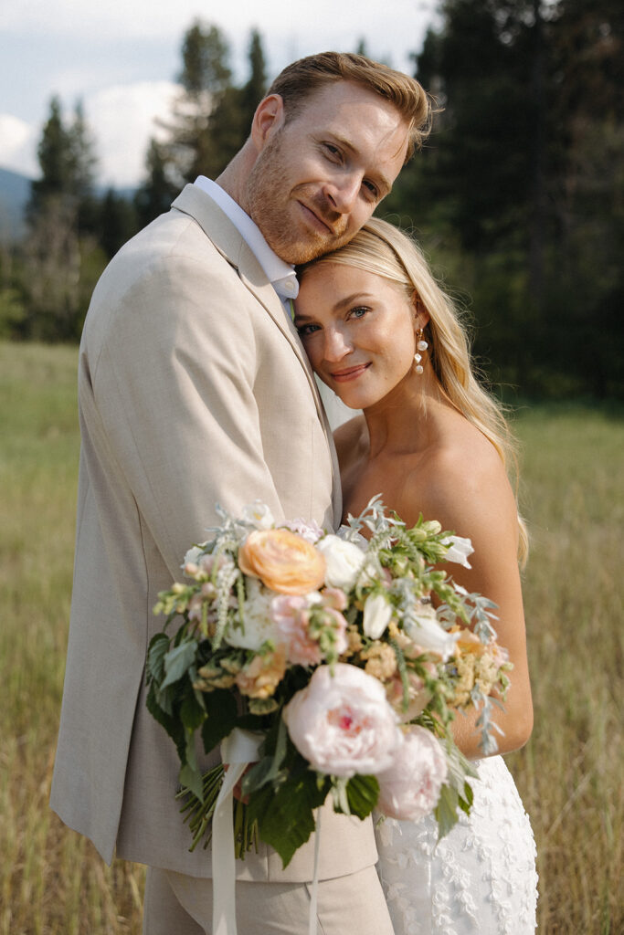 bride and groom leaning together smiling