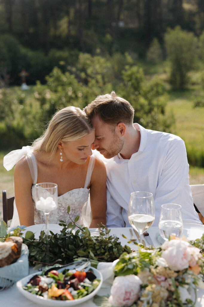 bride and groom leaning together praying at creekside meadows