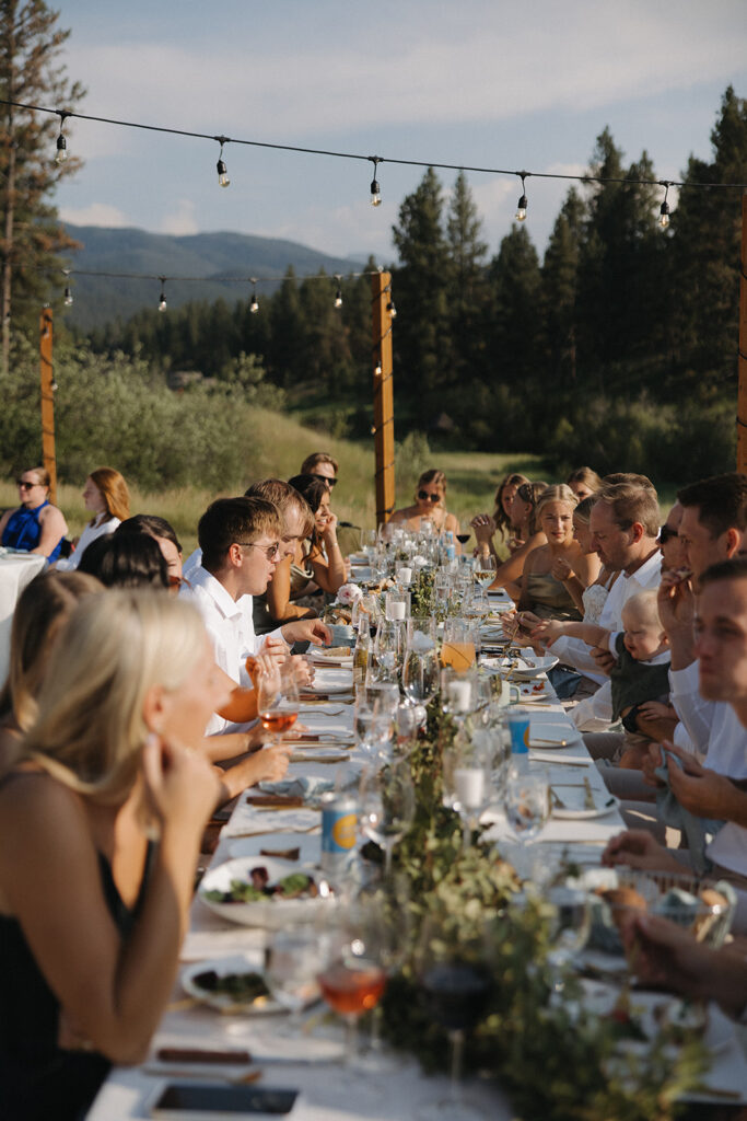 family and friends sharing a meal at montana wedding venue