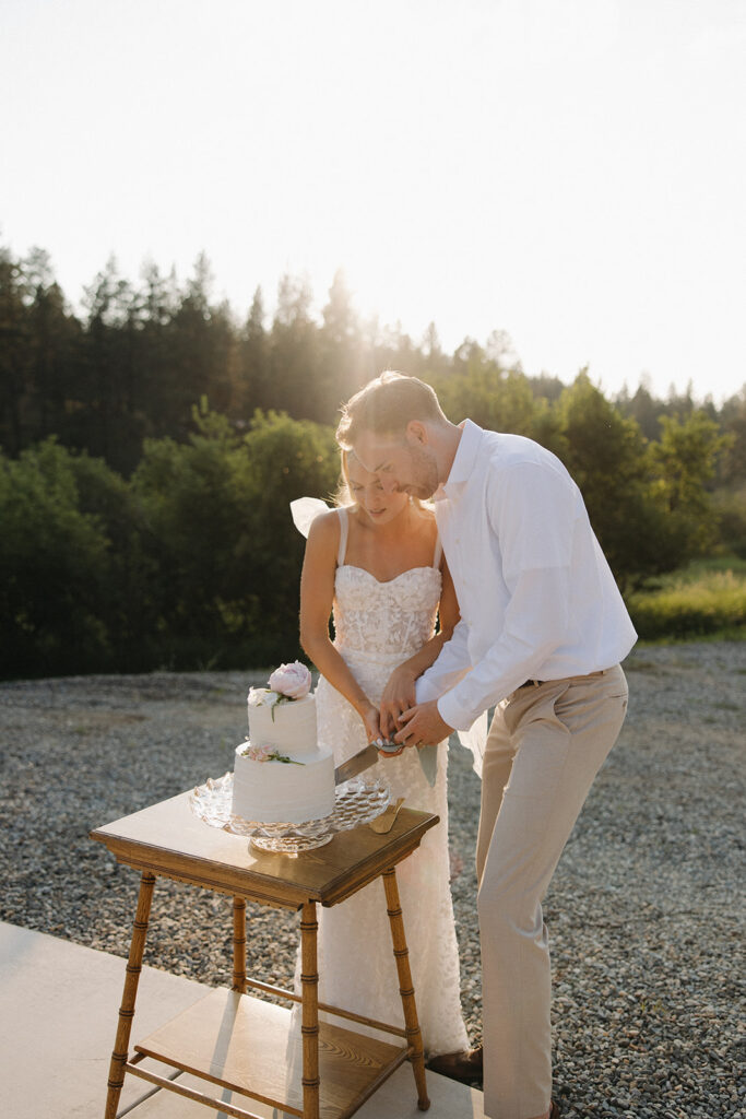 bride and groom cutting cake at montana wedding venue