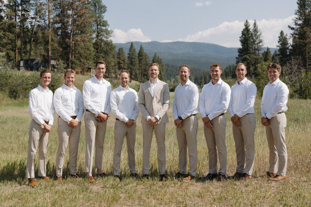 groomsmen standing in a field at montana wedding venue