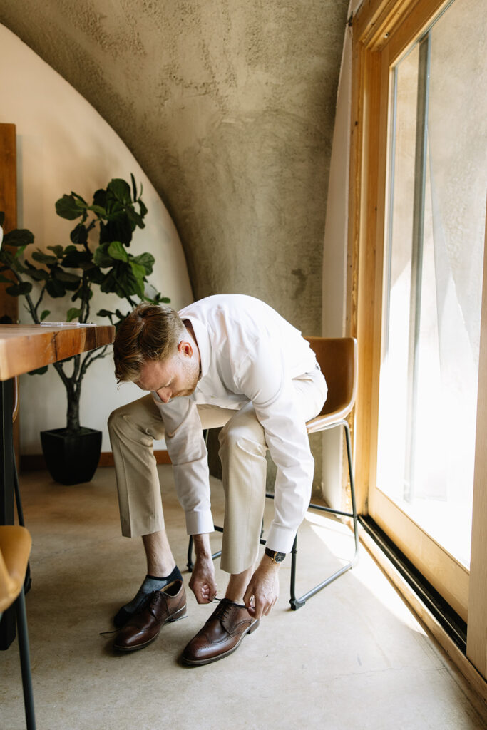 groom tying his shoe