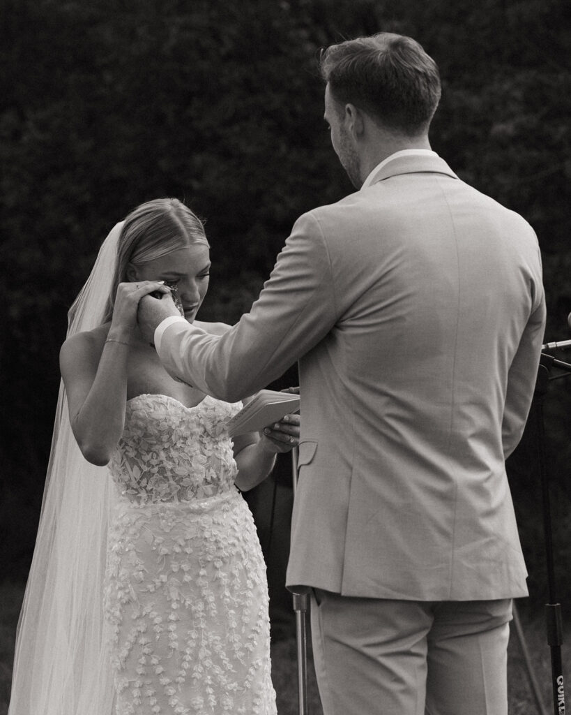 groom wiping away a tear during ceremony