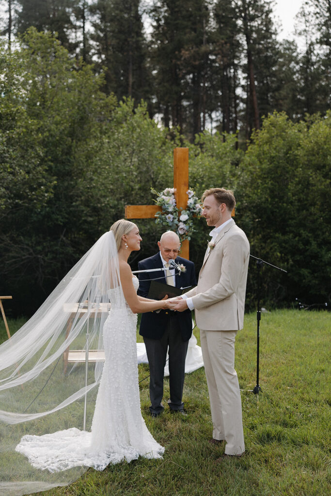 bride and groom looking at eachother during ceremony at montana wedding venue