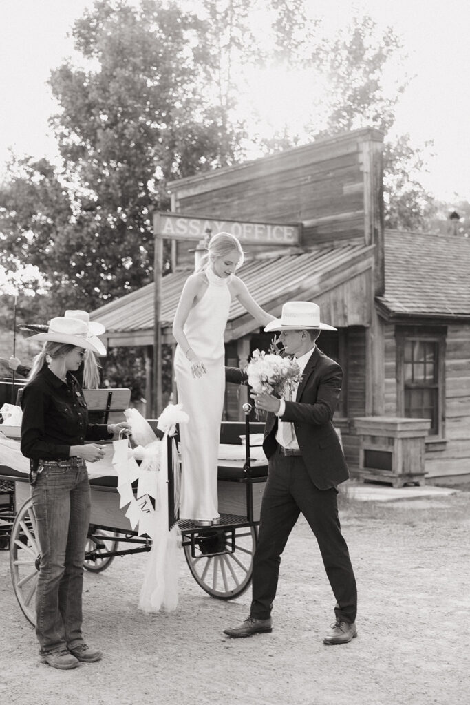 bride and groom ride horse drawn carriage at montana intimate wedding