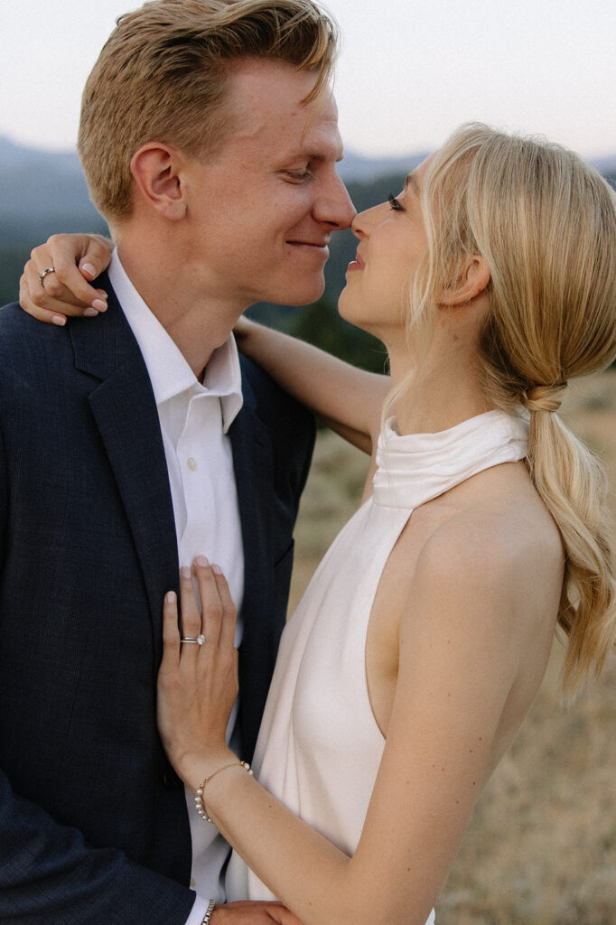 bride and groom smiling touching noses with eachother 