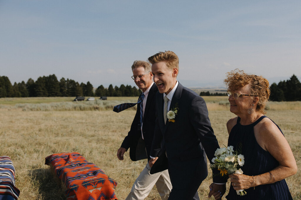 groom walks down the aisle at montana intimate wedding