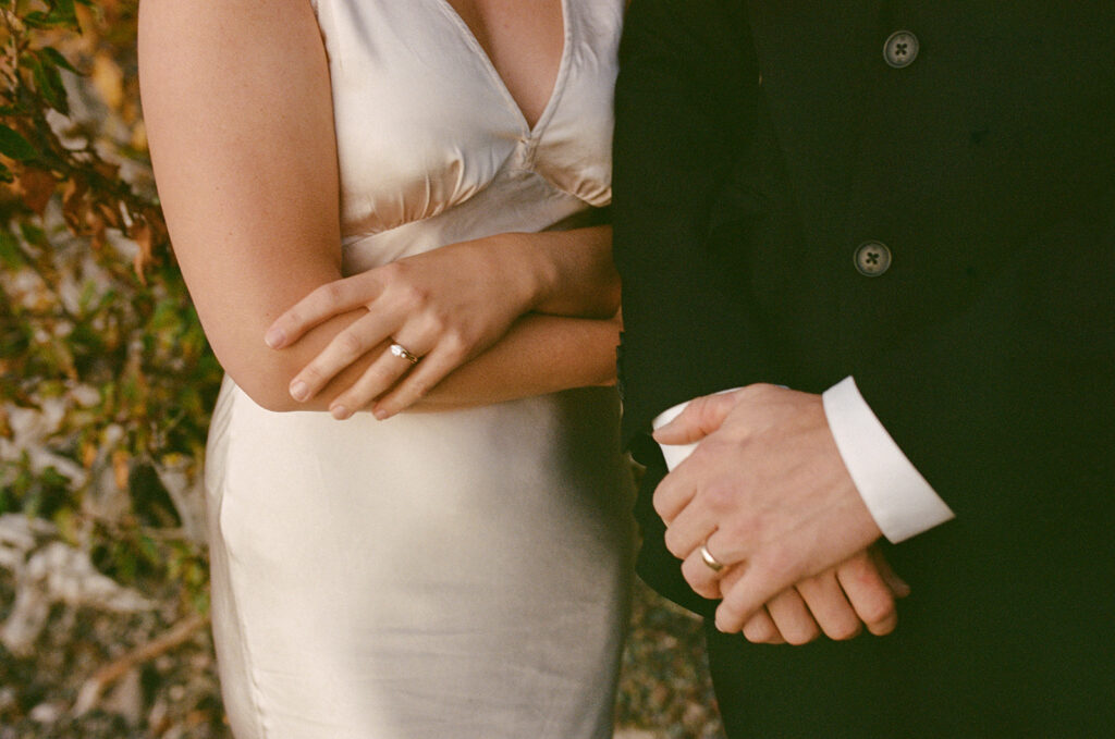 Couples hand show off rings in Glacier National Park