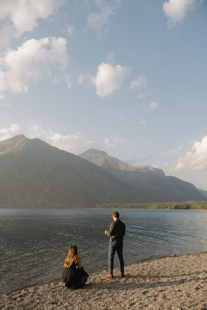 couple throws rocks into Lake McDonald
