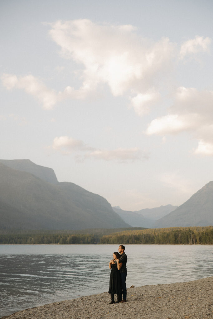 Couple stands next to Lake McDonald