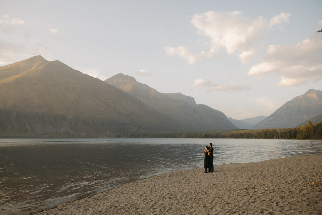 Couple stands next to Lake McDonald