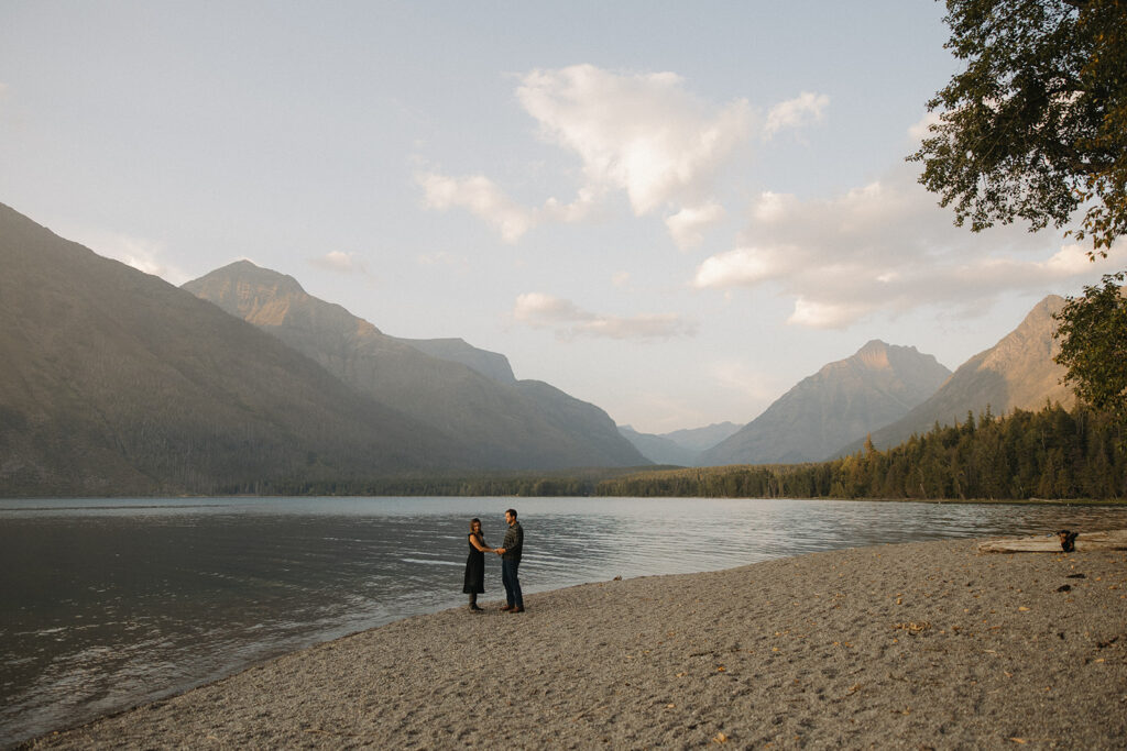 Couple stands next to Lake McDonald