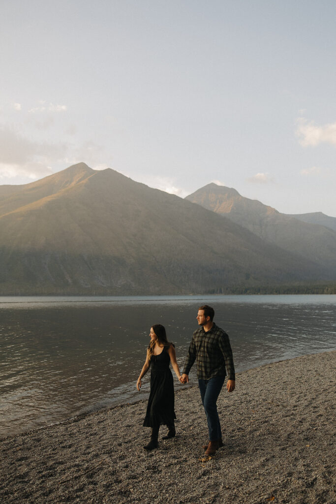 Couple walks next to Lake McDonald