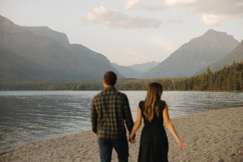 Couple stands next to Lake McDonald