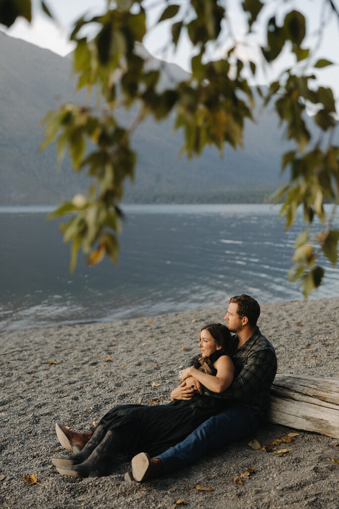 Couple sits next to Lake McDonald