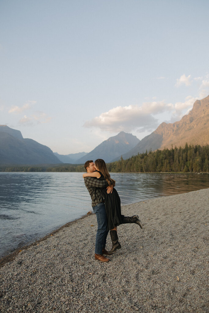 Couple kisses next to Lake McDonald