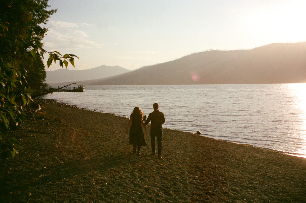 Couple stands next to Lake McDonald