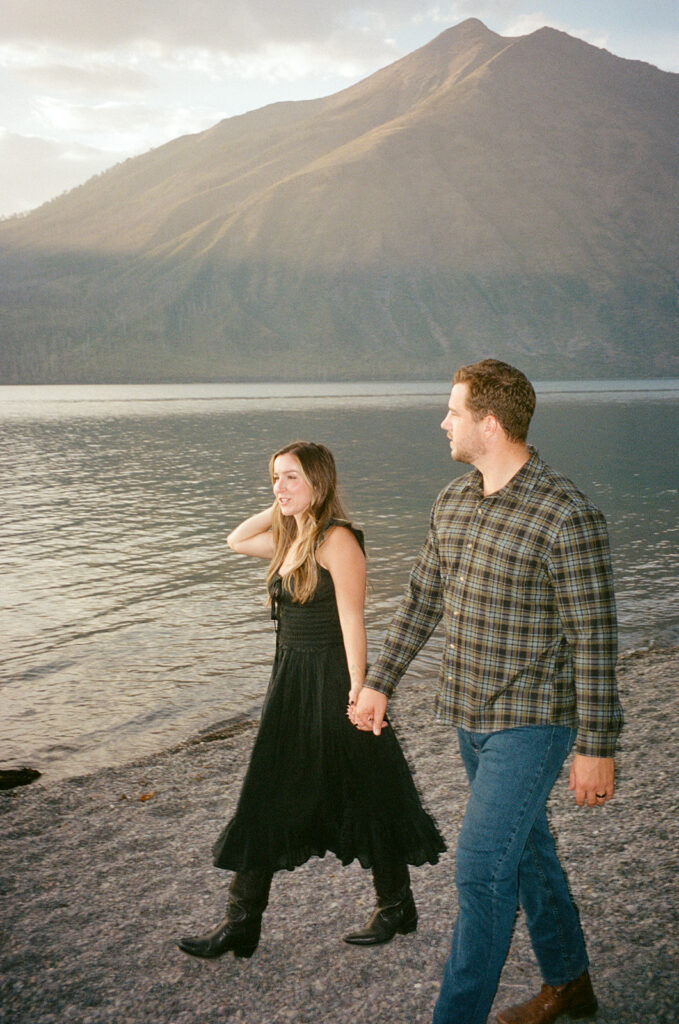 Couple stands next to Lake McDonald