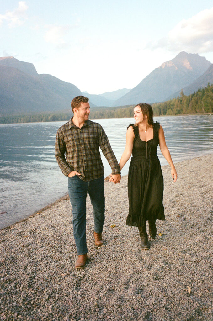 Couple walks next to Lake McDonald