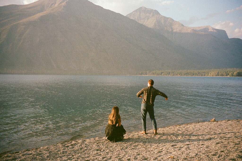 couple throws rocks into Lake McDonald
