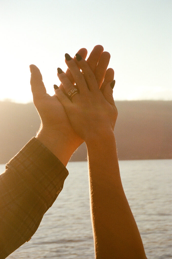 hands stretched out over  Lake McDonald