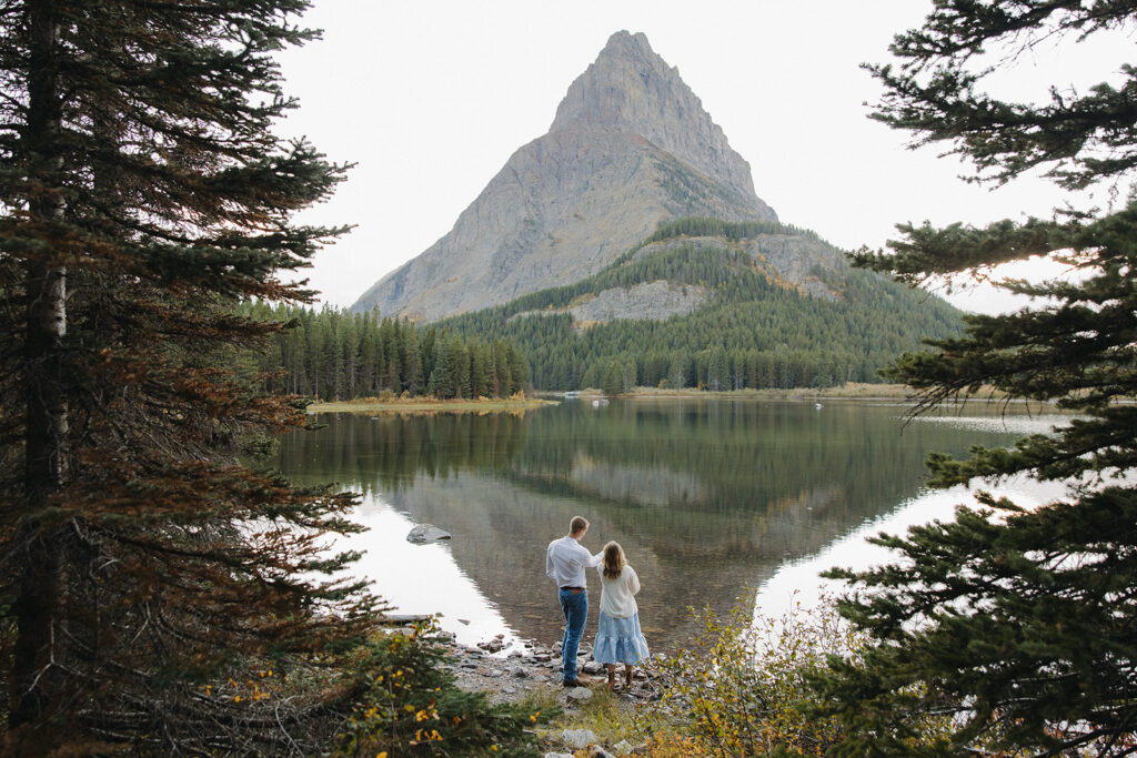 Couple standing at Swiftcurrent Lake 