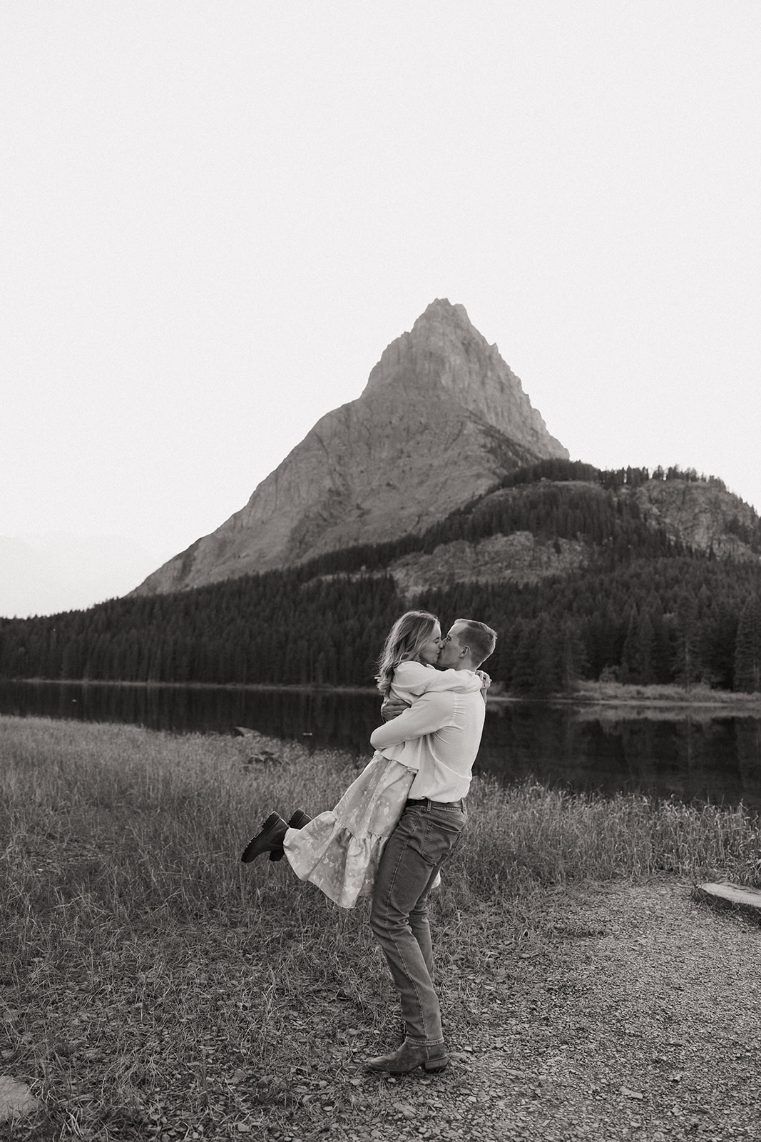 Couple kissing at Swiftcurrent Lake in Glacier National Park