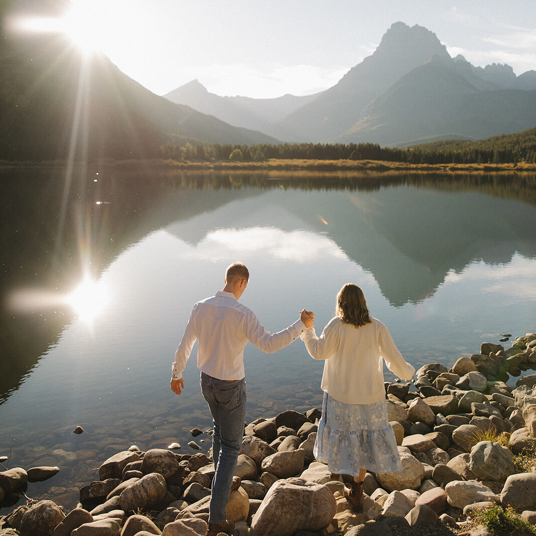 Couple walking at Swiftcurrent Lake in Glacier National Park