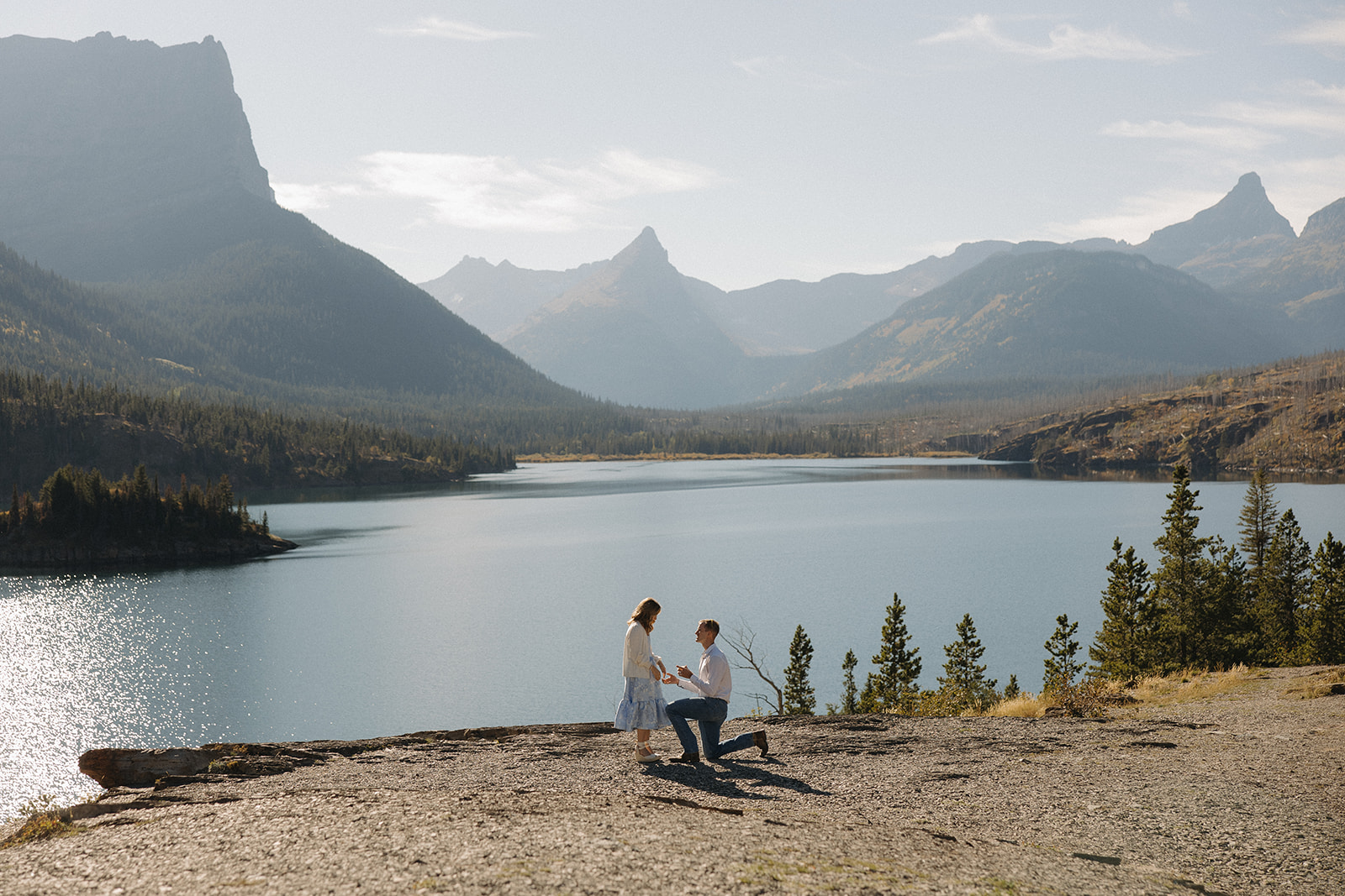 Couple getting engaged at Sun Point in Glacier National Park