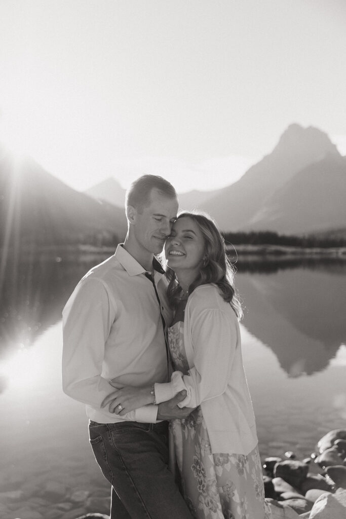 Couple standing at Swiftcurrent Lake in Glacier National Park