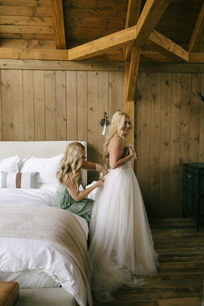 Bride getting dressed at Three Peaks Ranch Westcliffe Colorado
